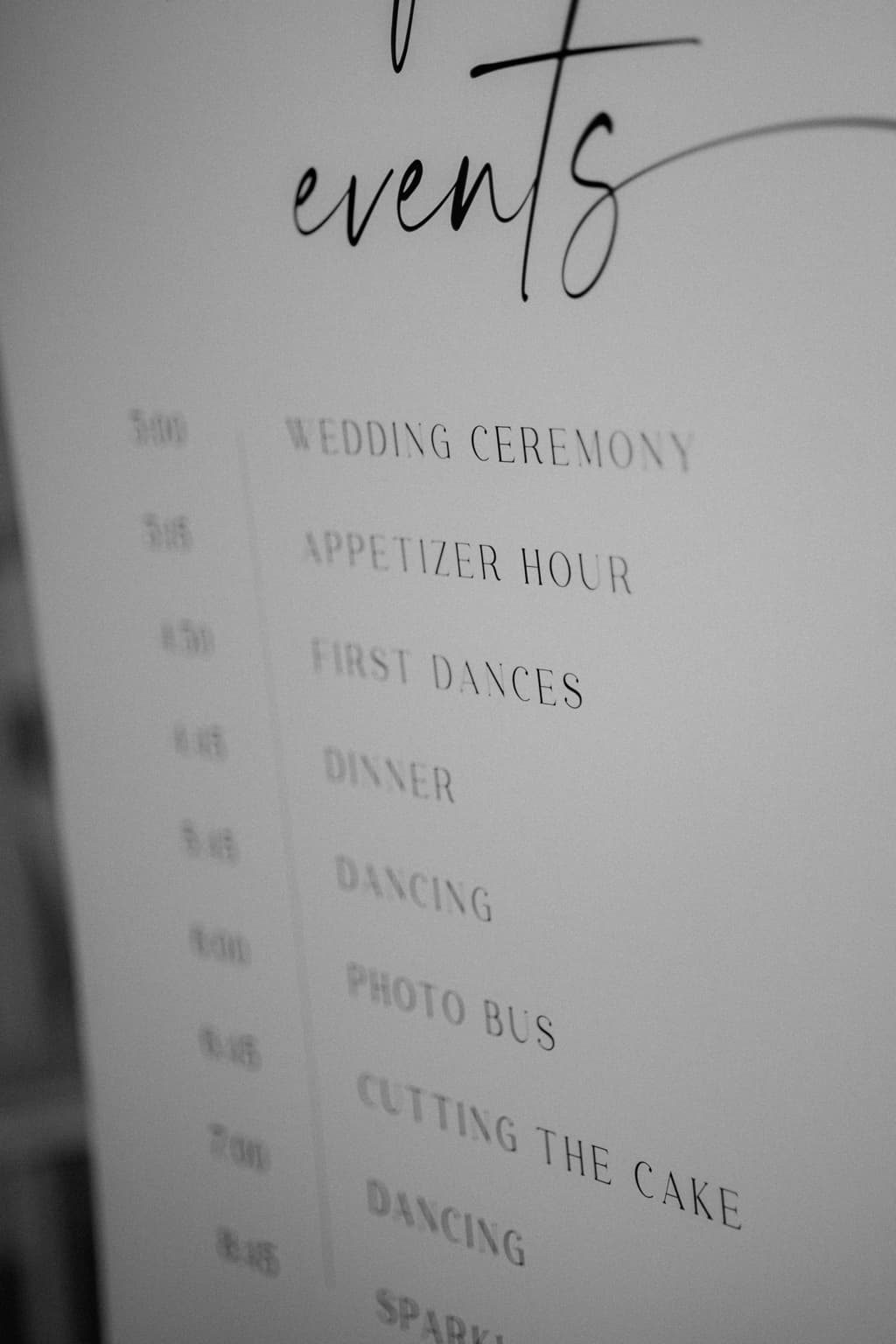 Black-and-white close-up of a printed wedding day timeline